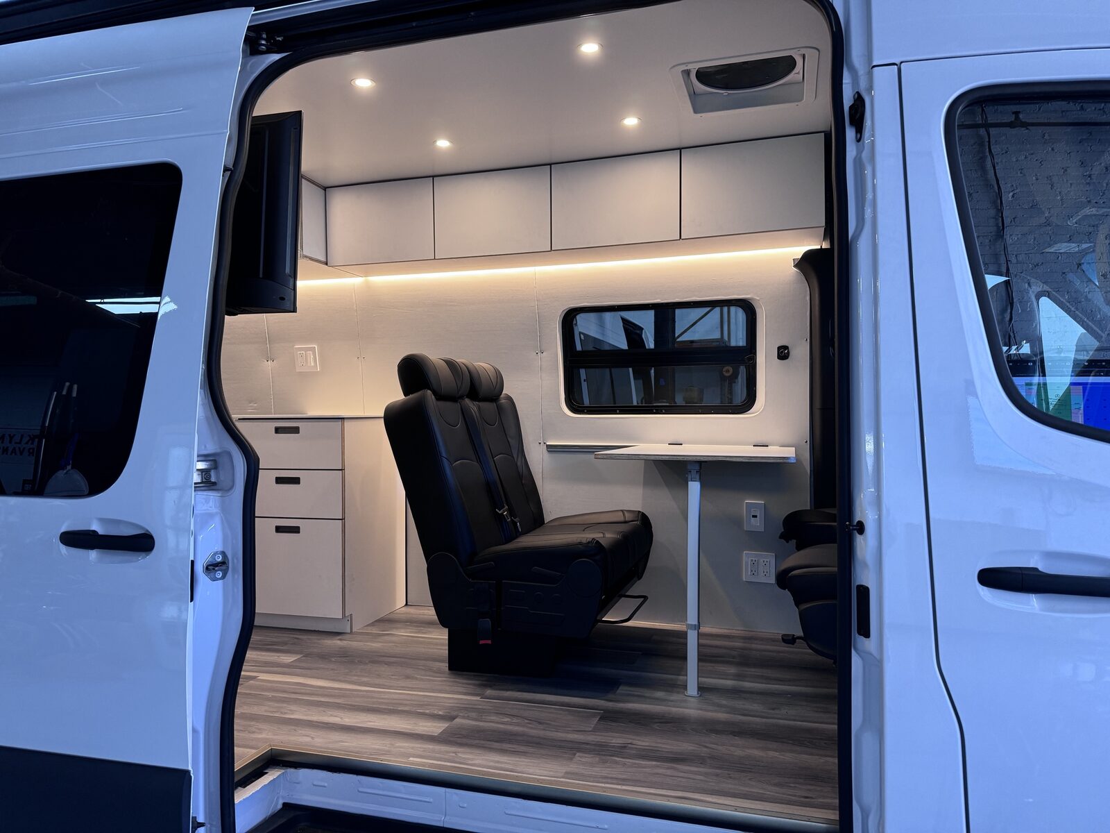 Sprinter mobile workspace interior through the open sliding door